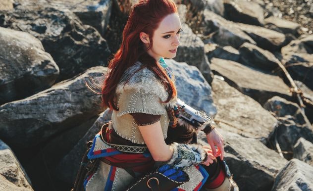 Pyroflyy in a cosplay with blue, red and beige clothing