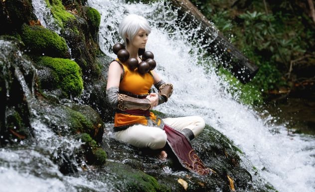 Pyroflyy sitting in meditation near a waterfall