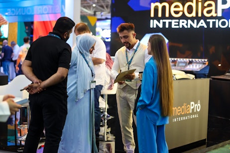 Female speaker presenting on event innovation and trends at SES 2025 in Riyadh