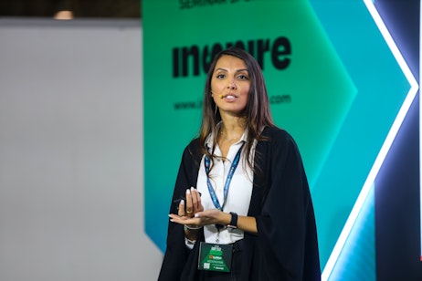 Speaker presenting at Inspire stage at SES 2025, focused on innovation and trends