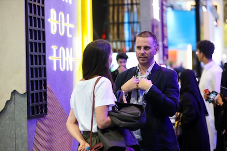 Visitors discussing creative event solutions and partnerships at SES 2025 in Riyadh