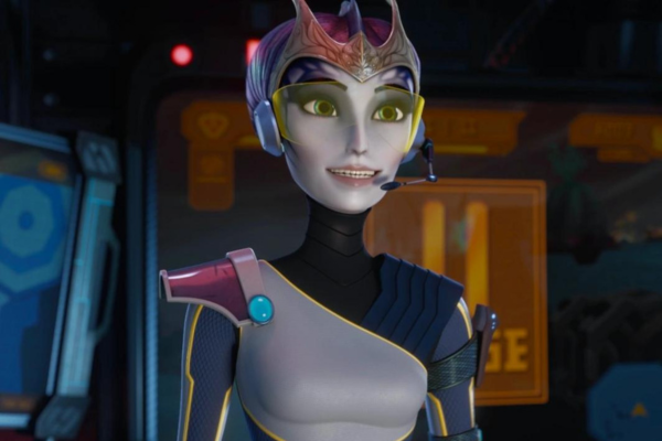 Elaris with a headset on with yellow eye protection smiling.