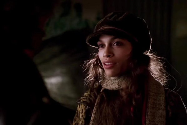 Rosario Dawson in a hat and a scarf.