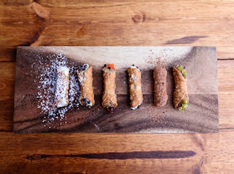 cannolis in various flavors on a tray