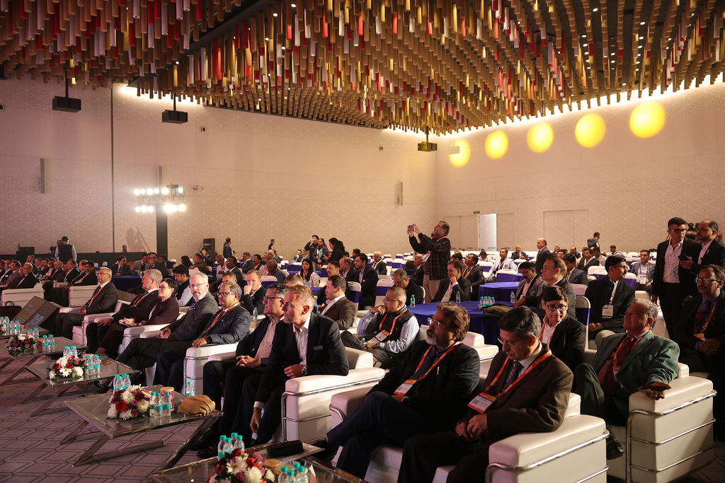 Attendees at a business conference or seminar seated at tables.