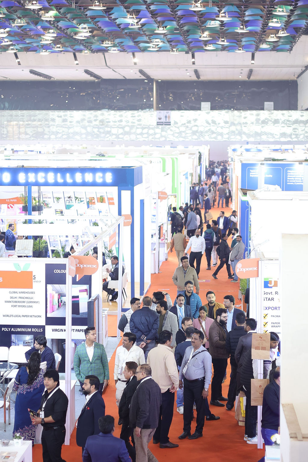 Attendees walking through the corridor, exploring various booths on display at Paperex