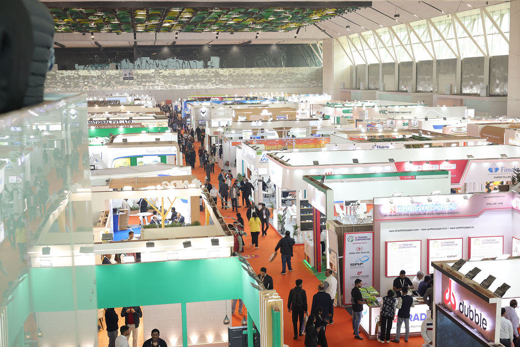 Attendees walking through the corridor, exploring various booths on display at Paperex