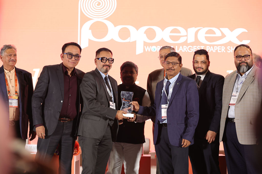Two men in suits holding an award during the ceremony on stage