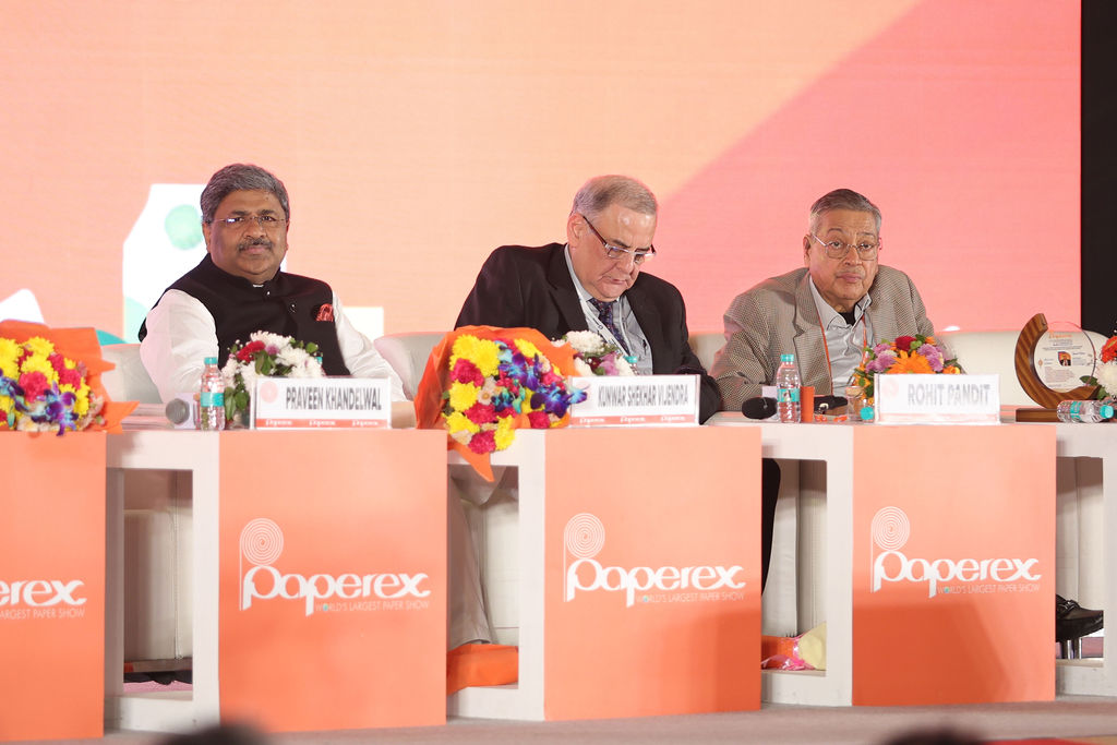 Group of professionals at an award ceremony with someone holding a trophy.
