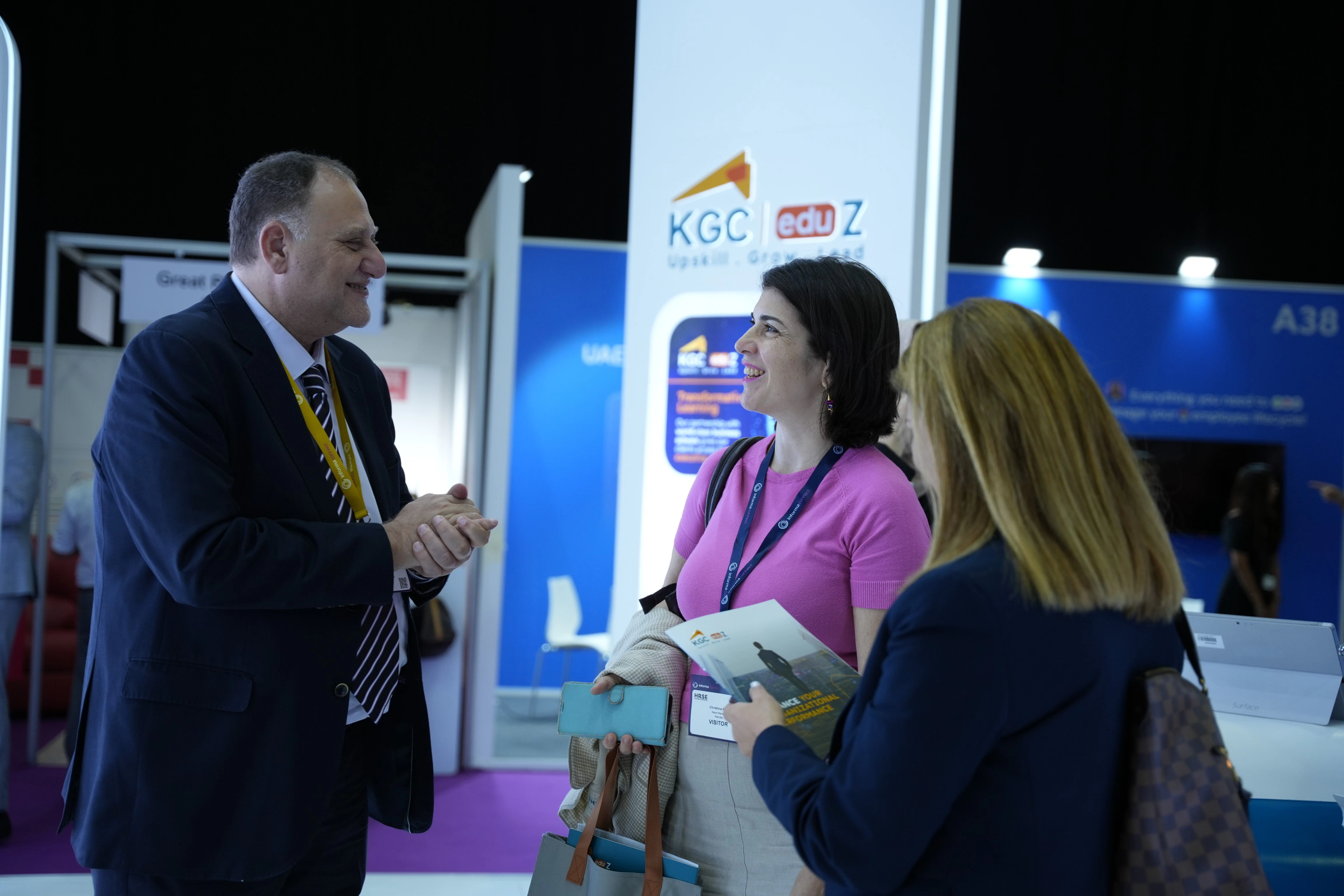 Panel discussion at the HRSE, featuring a woman speaking on stage with five other panelists.