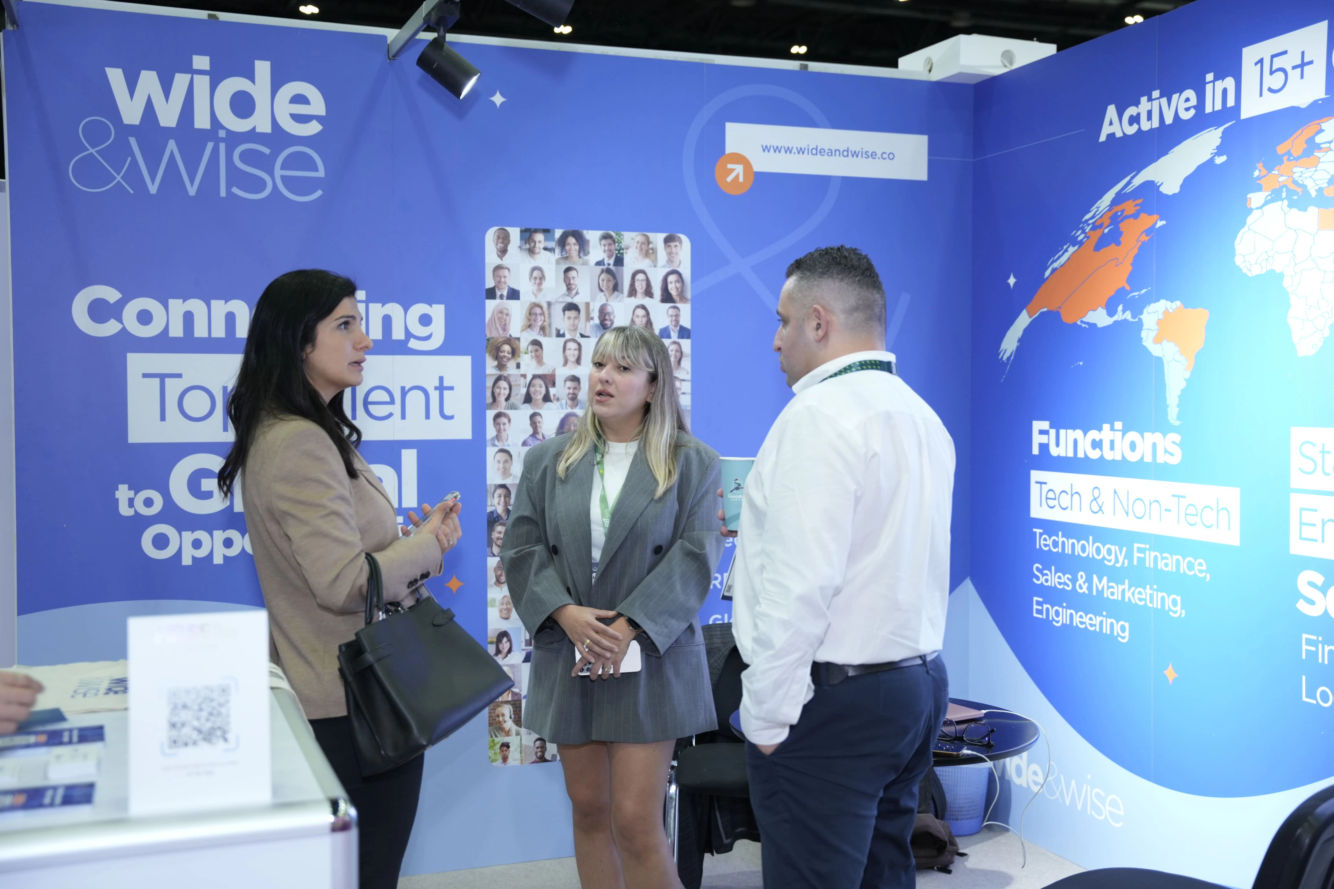 Professionals networking at HRSE Summit with various booths