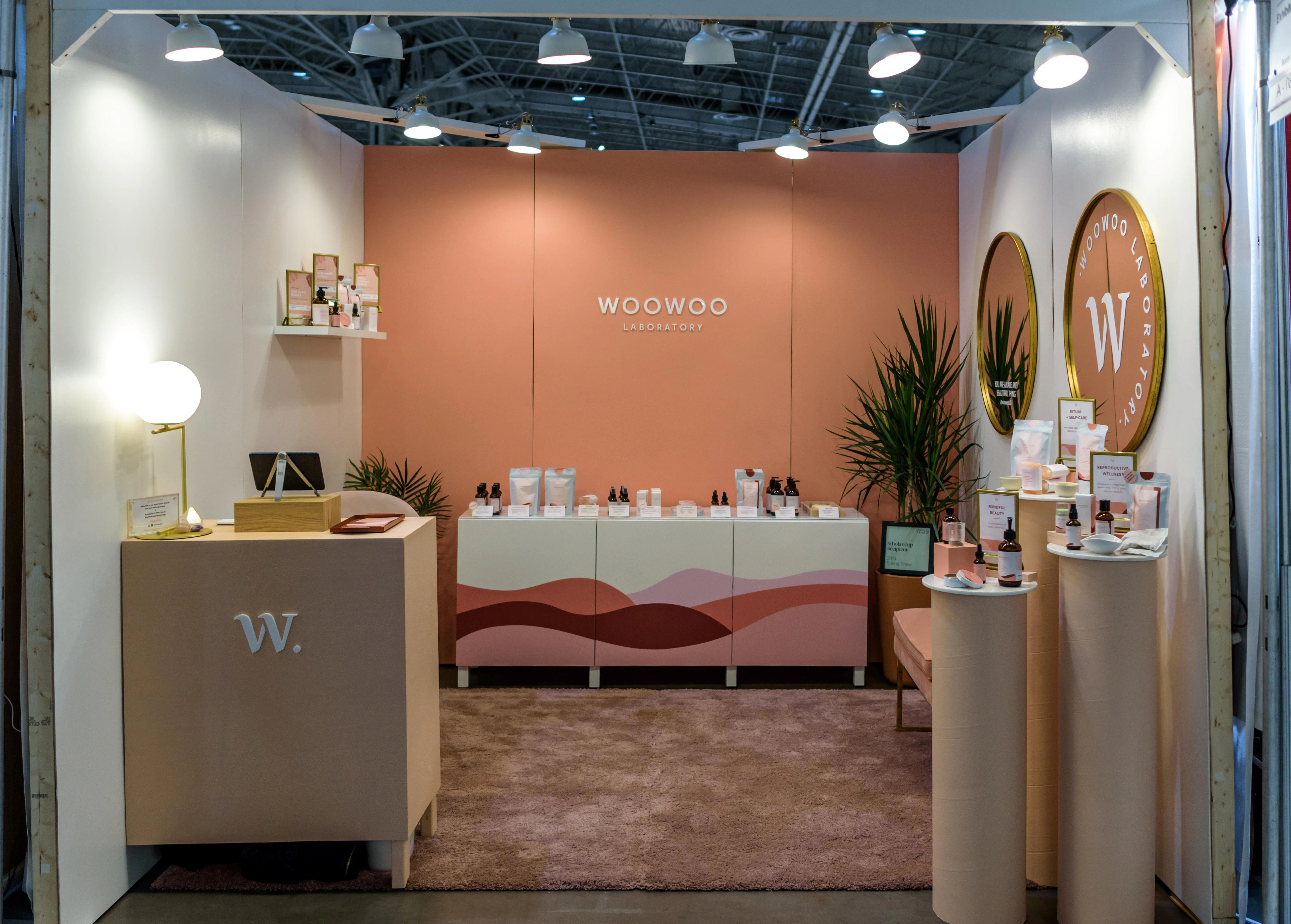 Exhibitor-provided carpet being used to bring a cozy feel to the booth