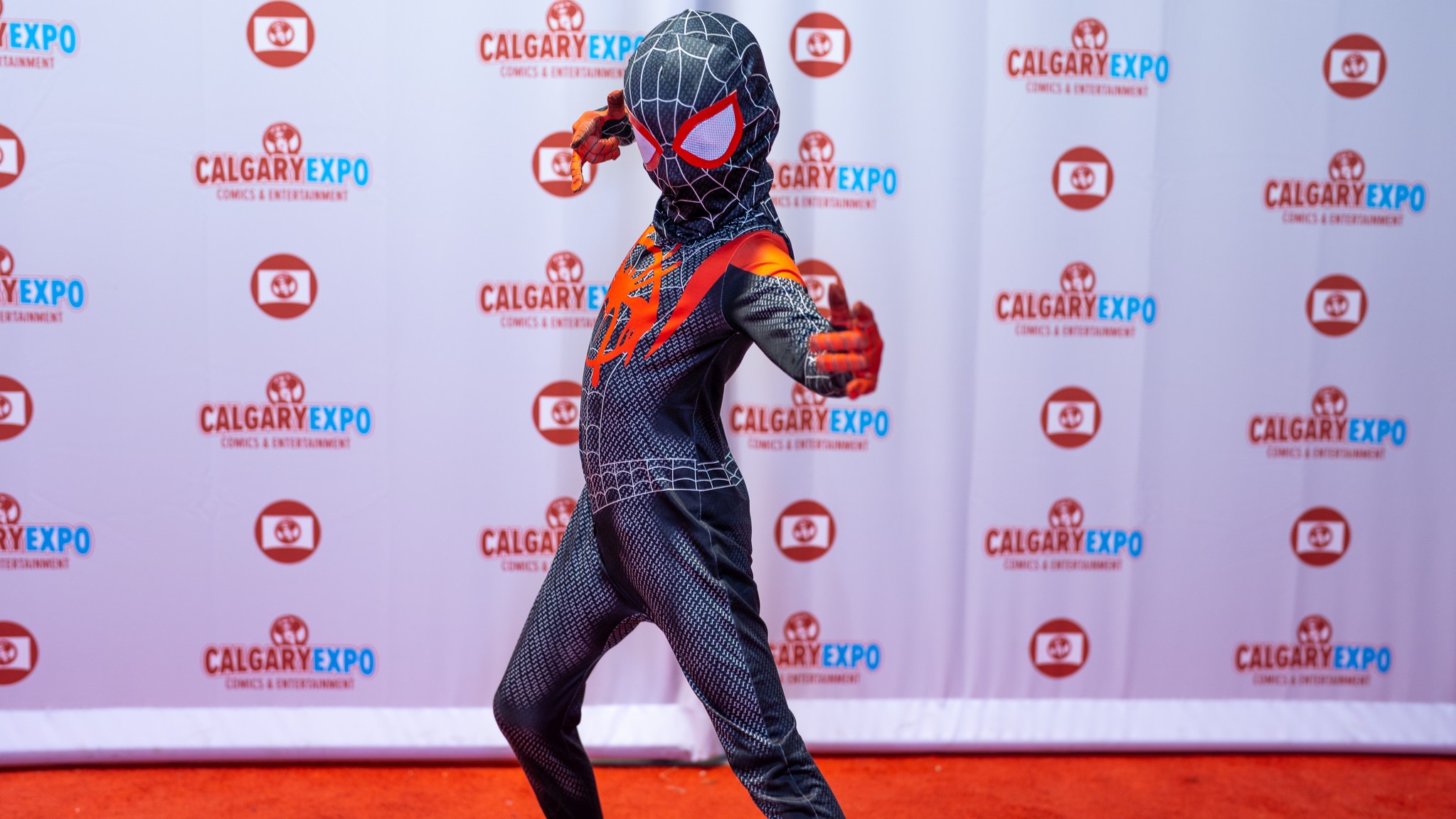 A child cosplaying Spiderman poses on the Red Carpet