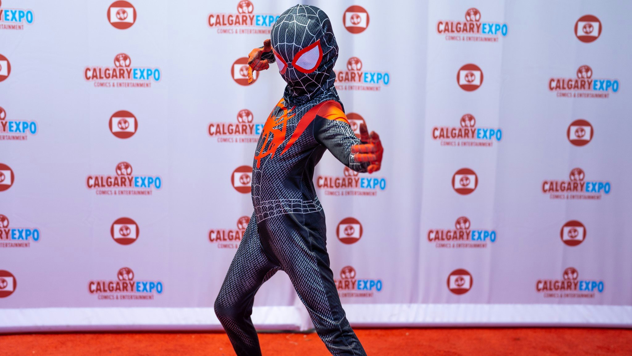 A child cosplaying Spiderman poses on the Red Carpet
