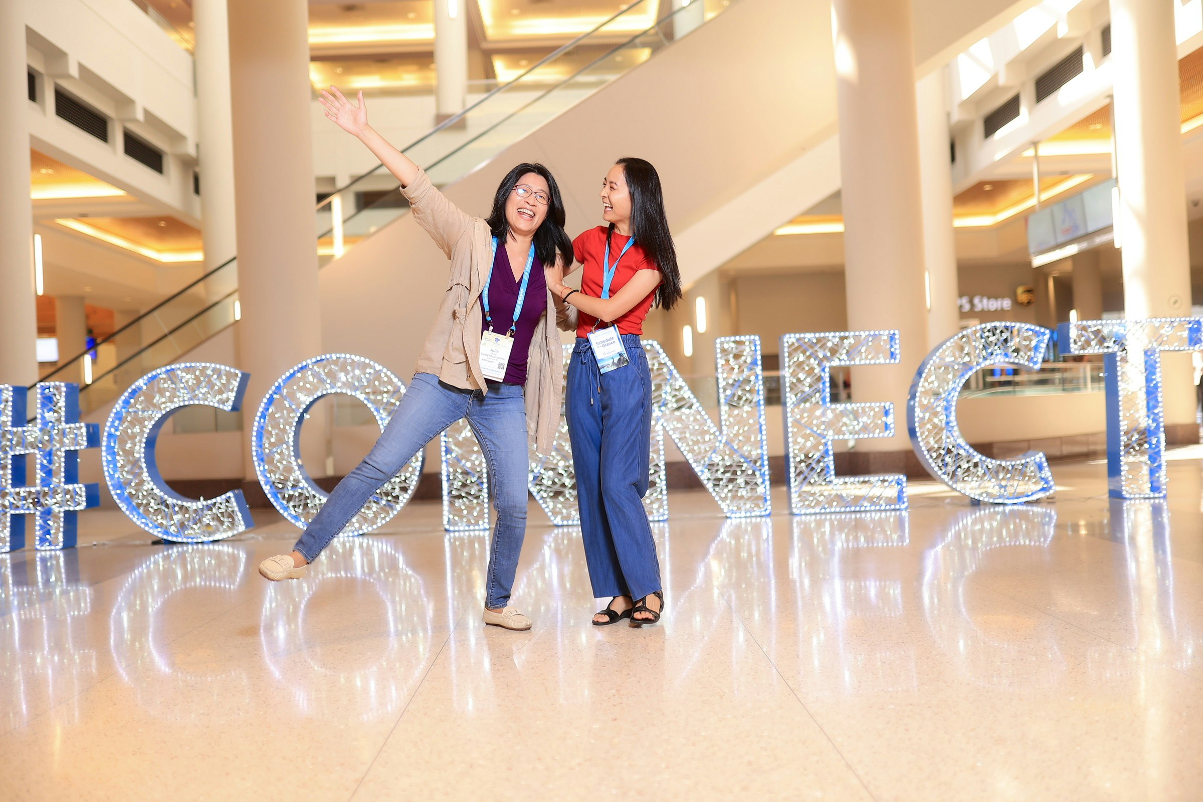 Two women standing in front of Connect sign