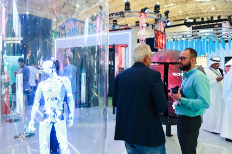 Visitors engaging with an immersive AI-powered experience at SES 2025 in Riyadh