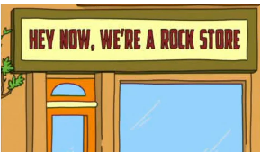 A plain sign on the orange storefront. The sign is yellow with a red, blocky font that says "Hey Now, We're a Rock Store"