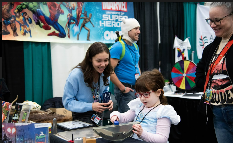 the staff at OMSI eagerly engage with children as they try out the hands on aspects of their booth