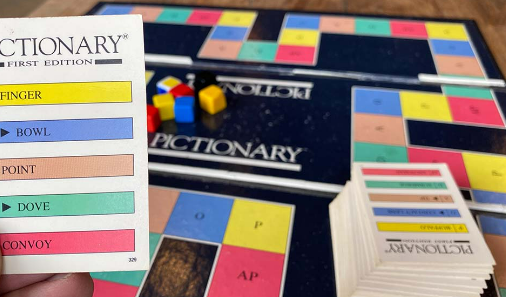 Pictionary card being held above the board. The image options are Finger, Bowl, Point, Dove, and Convoy