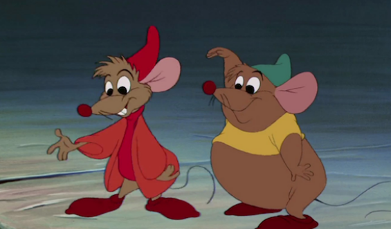 Jaq (brown rat with a red hat and jacket) and Gus-Gus, a rotund brown rat with a yellow crop top and green hat watch as Fairy Godmother helps Cinderella. They imitate her using her magic
