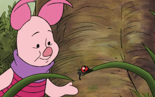 Piglet, wearing a purple scarf in the hundred acre wood, helps a ladybug off of a long blade of grass.