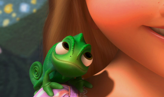 Pascal the Chameleon sits on Rapunzel's shoulder - he stares longingly at her as she speaks.