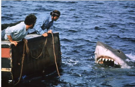 Brody and Hooper throwing the tank into the shark's mouth over the edge of the boat.