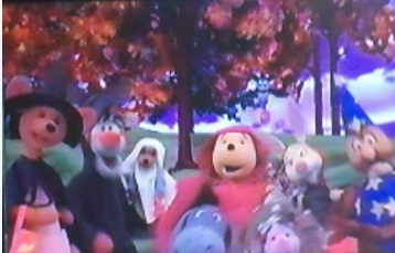 The hundred achre wood gang gather by the changing tree. Kanga, dressed as a witch. Tigger, a wolf. Roo, a ghost. Pooh, little red riding hood, Rabbit, a vampire, Owl, a wizard, Piglet, a mountain.
