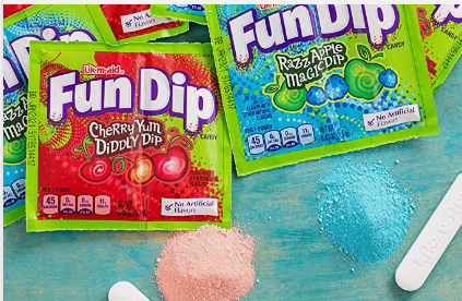 packages if Fun Dip line the top of the image, the flavours are cherry and razz apple. toward the bottom, there are piles on the powder in each flavour, and the candy dip sticks are next to them.