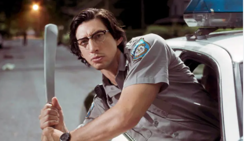 Adam Driver, hanging out the window of a police car, wields a machete as he looks out for zombies