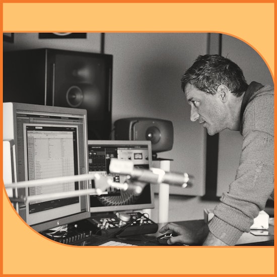 Sound technician looking at a computer screen in a studio