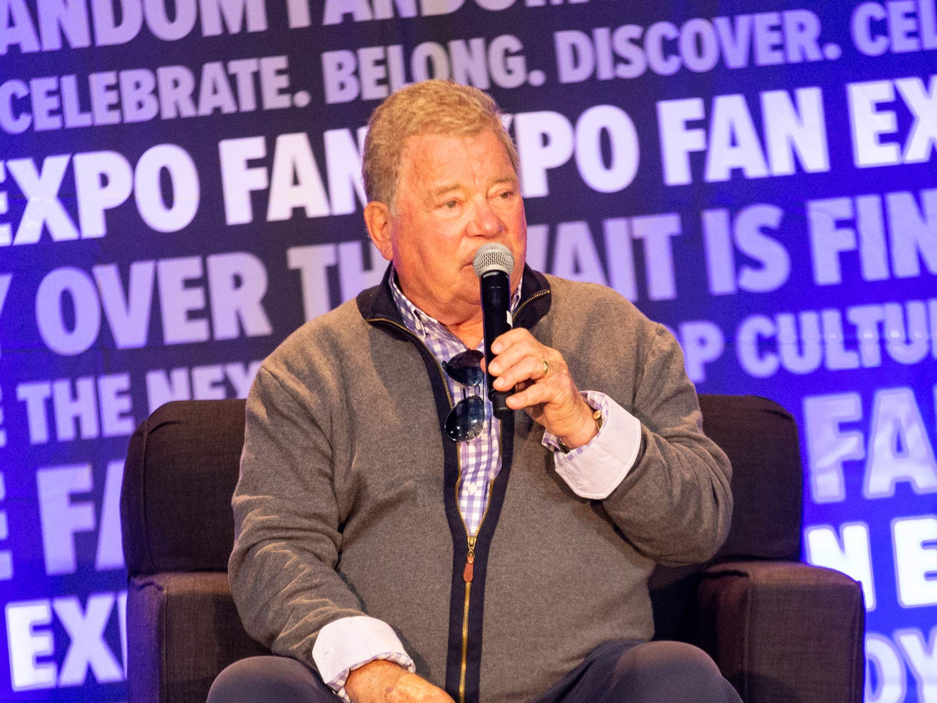William Shatner on stage holding a microphone