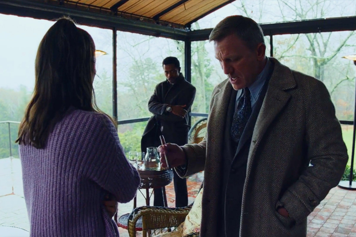 Benoit Blanc looking down at Marta's shoes