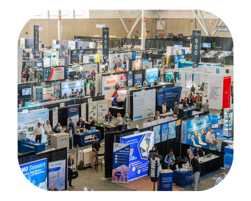 A bustling convention hall filled with numerous attendees engaging in various activities during the event.