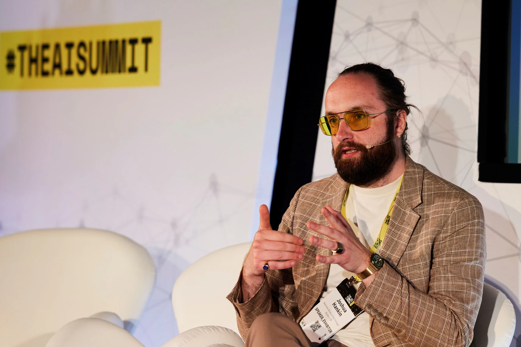 A speaker makes a point to the audience at The AI Summit London