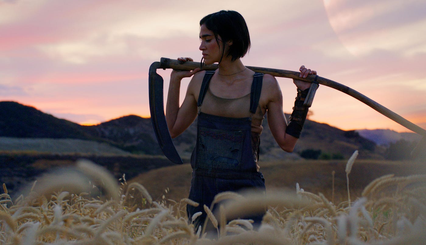 Sofia Boutella as Rebel Moon standing in a field