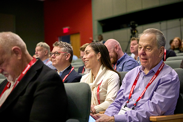 Attendees focused on conference sesson they are attending