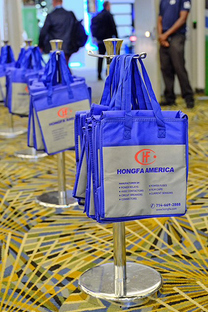 an Exhibitor is shaking hands with an attendee on the expo hall