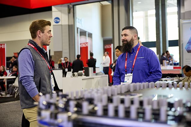 Two men engaged in conversation at The Battery Show