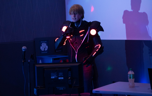A cosplayer singing karaoke