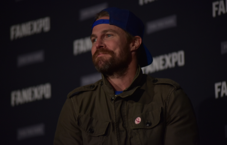 Stephen Amell on stage, smiling