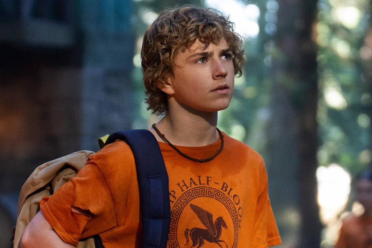 Percy wears an orange shirt and looks confused