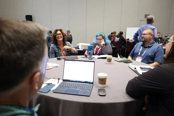 Students collaborate during a roundtable discussion in the Knowledge-Centered Service (KCS) Principles course.