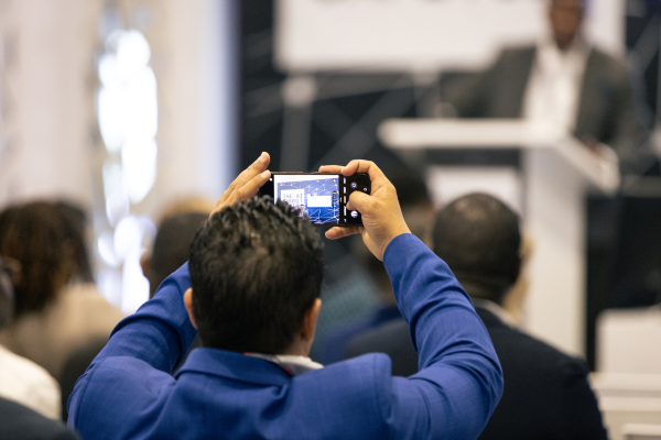 Delegate taking photo of presentation