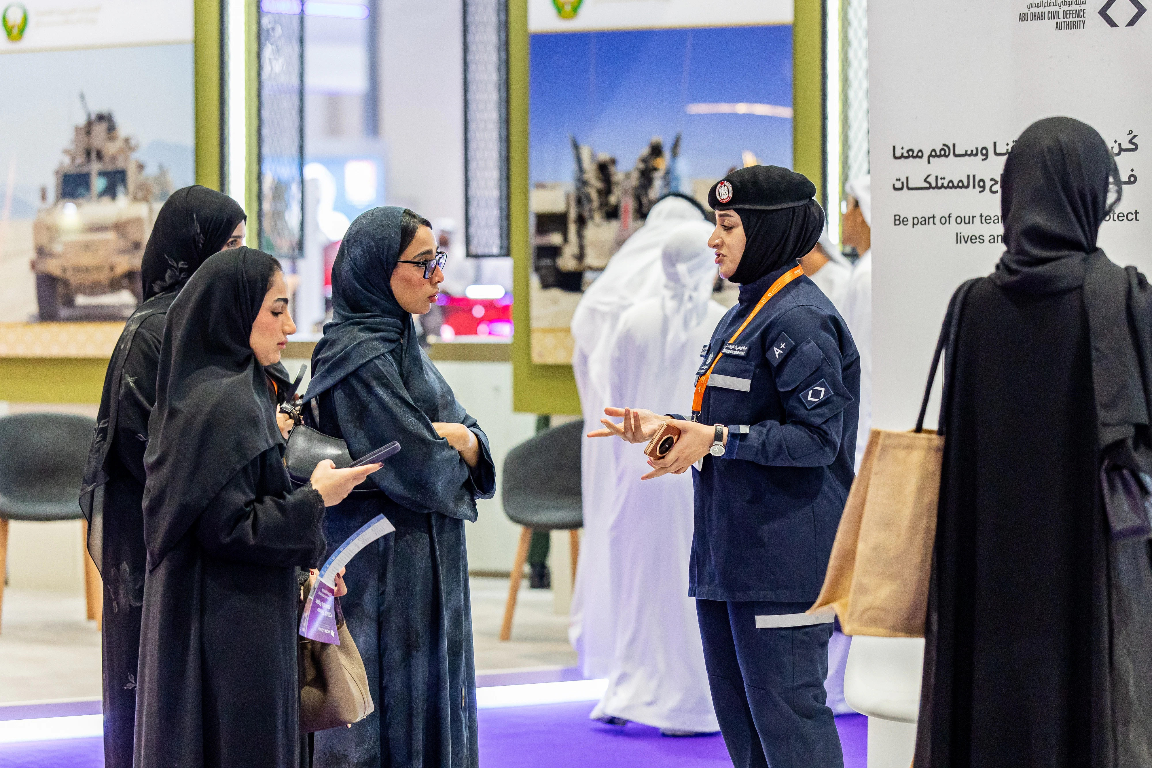 Employers discussing career opportunities with Emirati visitors at Tawdheef x Zaheb 2025 Emiratisation festival.