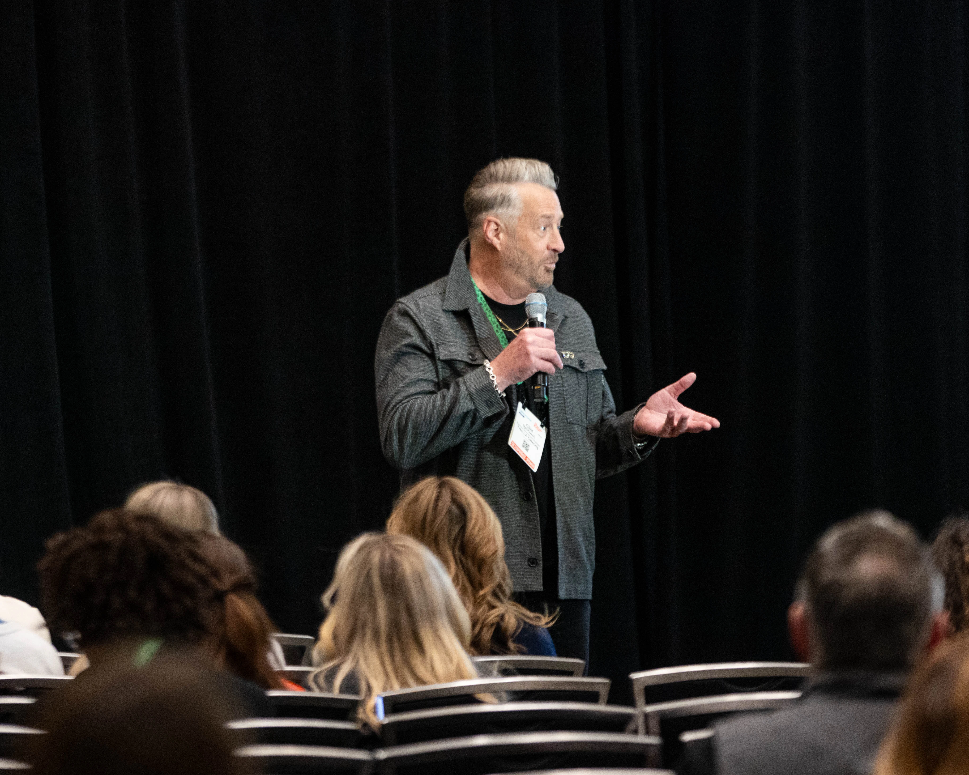 A speaker holding a microphone