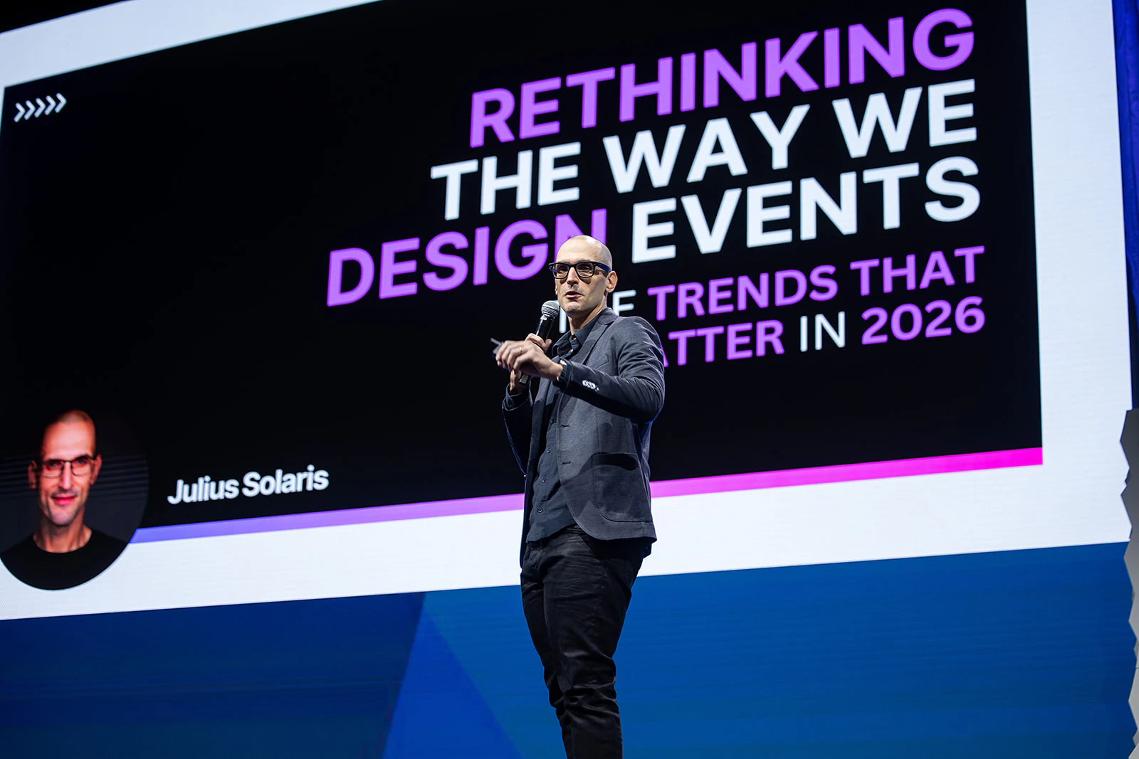 Julius Solaris presenting on stage at Cater+Event