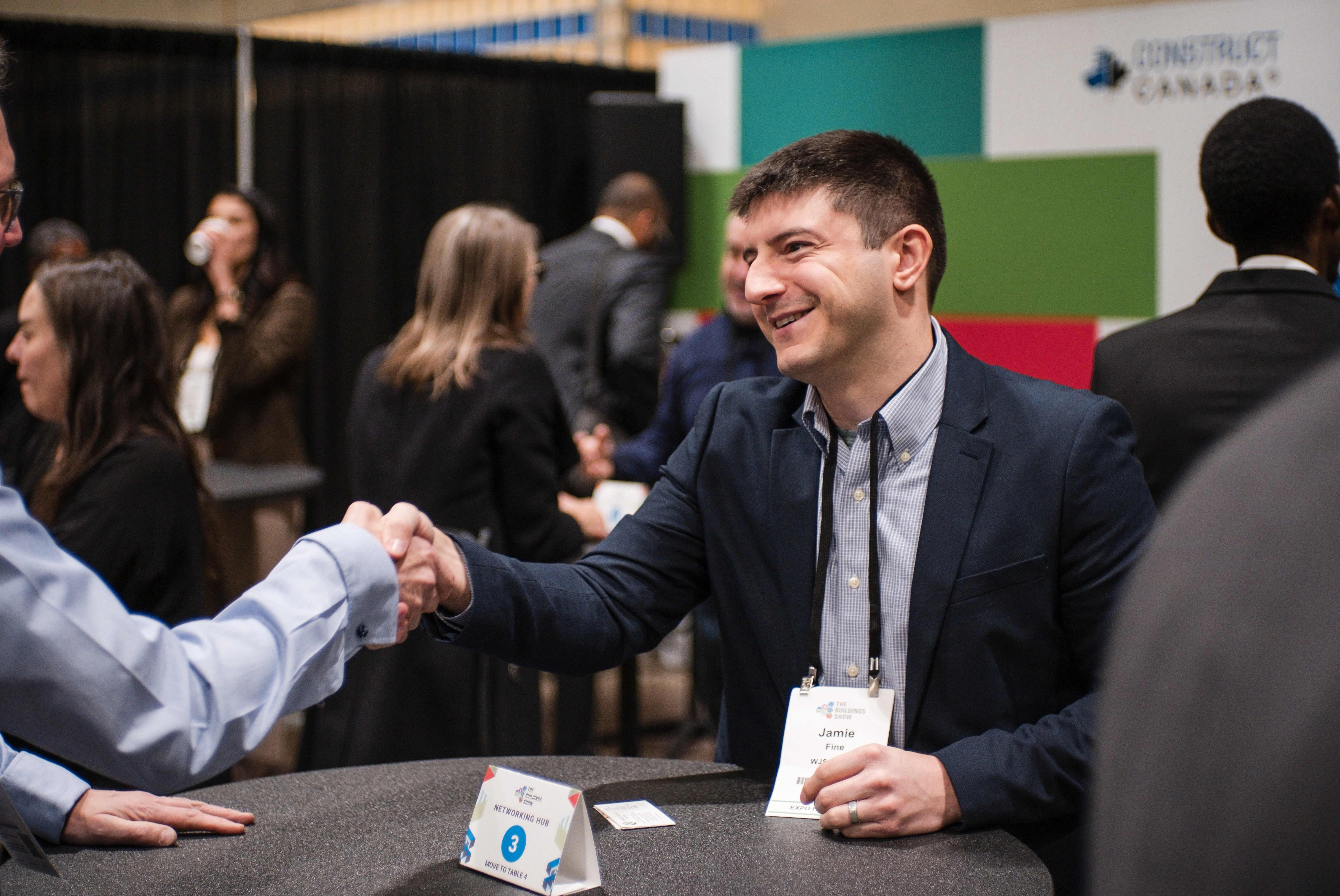 Several small tables of 2 attendees chatting during The Buildings Show Speed Networking sessions