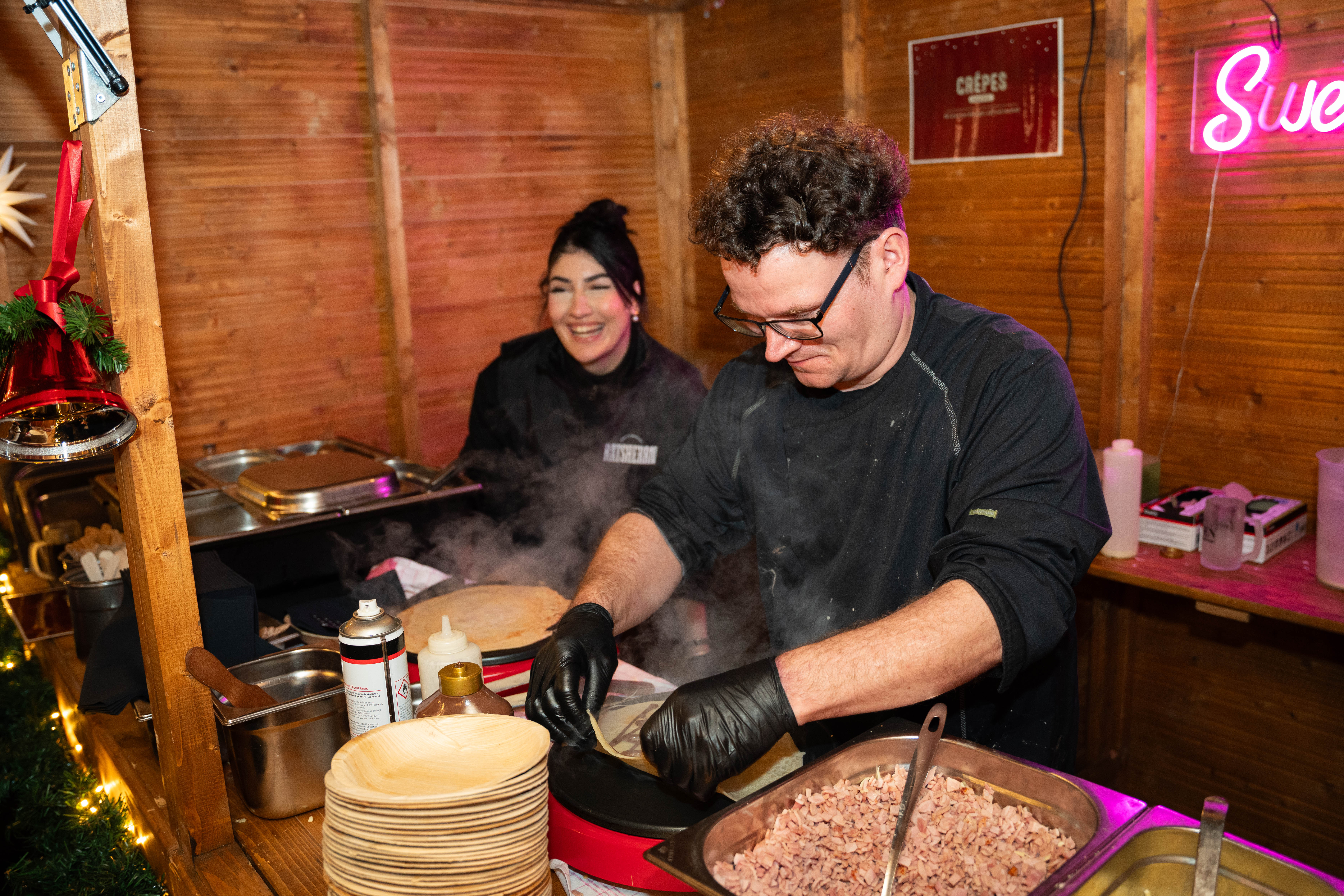 Two staff members make crepes.