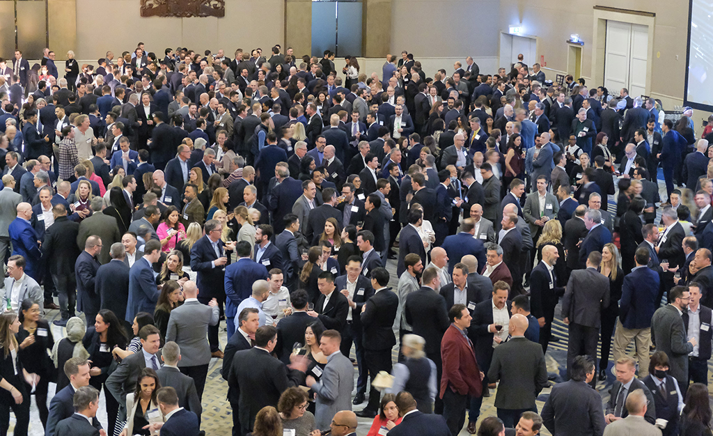 Real estate conference attendees exchanging contact info